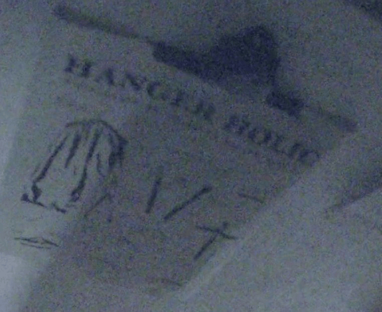 A poster on the wall, with text reading 'Hanger Holic' and various illustrations of clothes hangers.